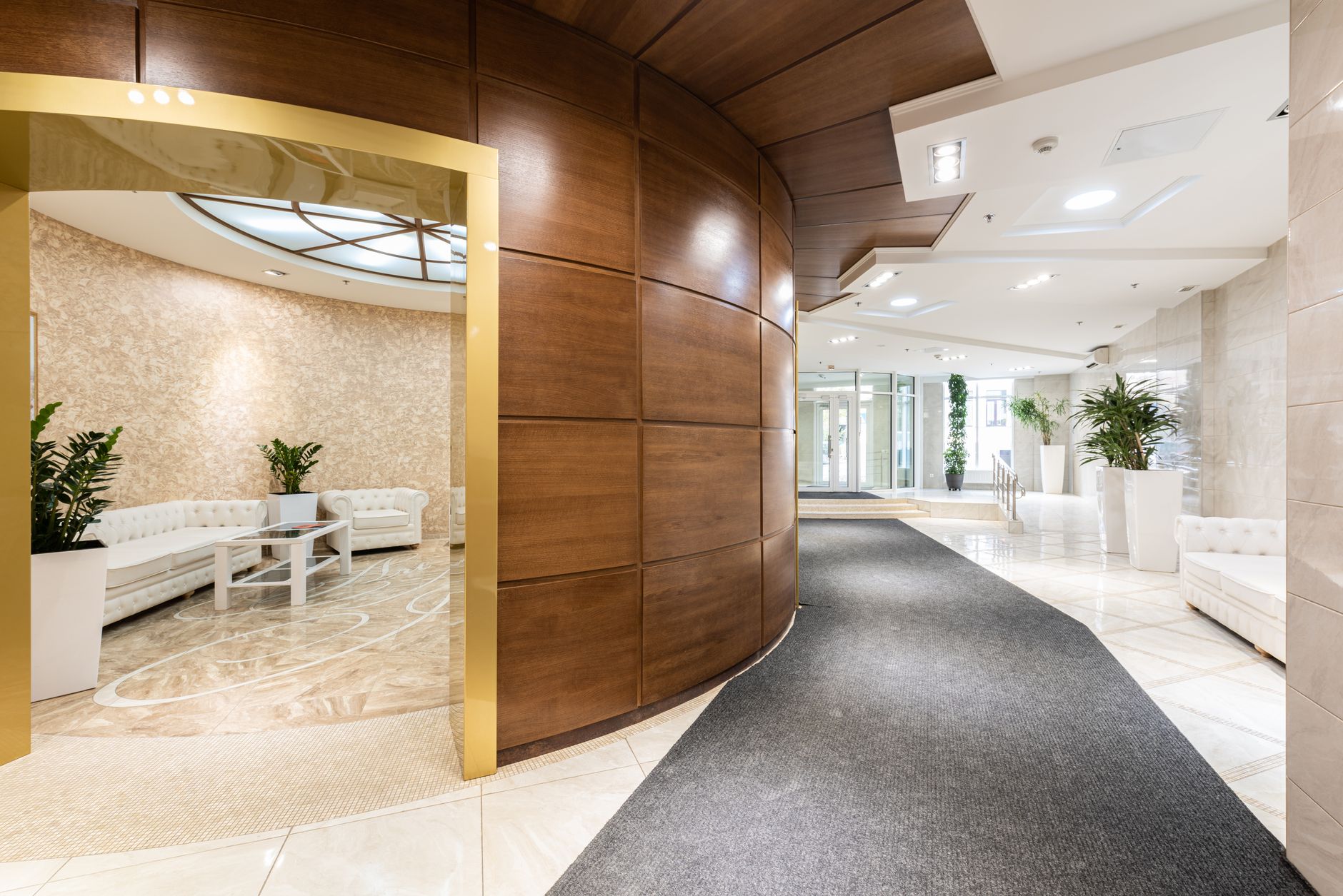 An empty, ultra-modern hotel lobby featuring sleek automated check-in kiosks and geometric architectural lines.