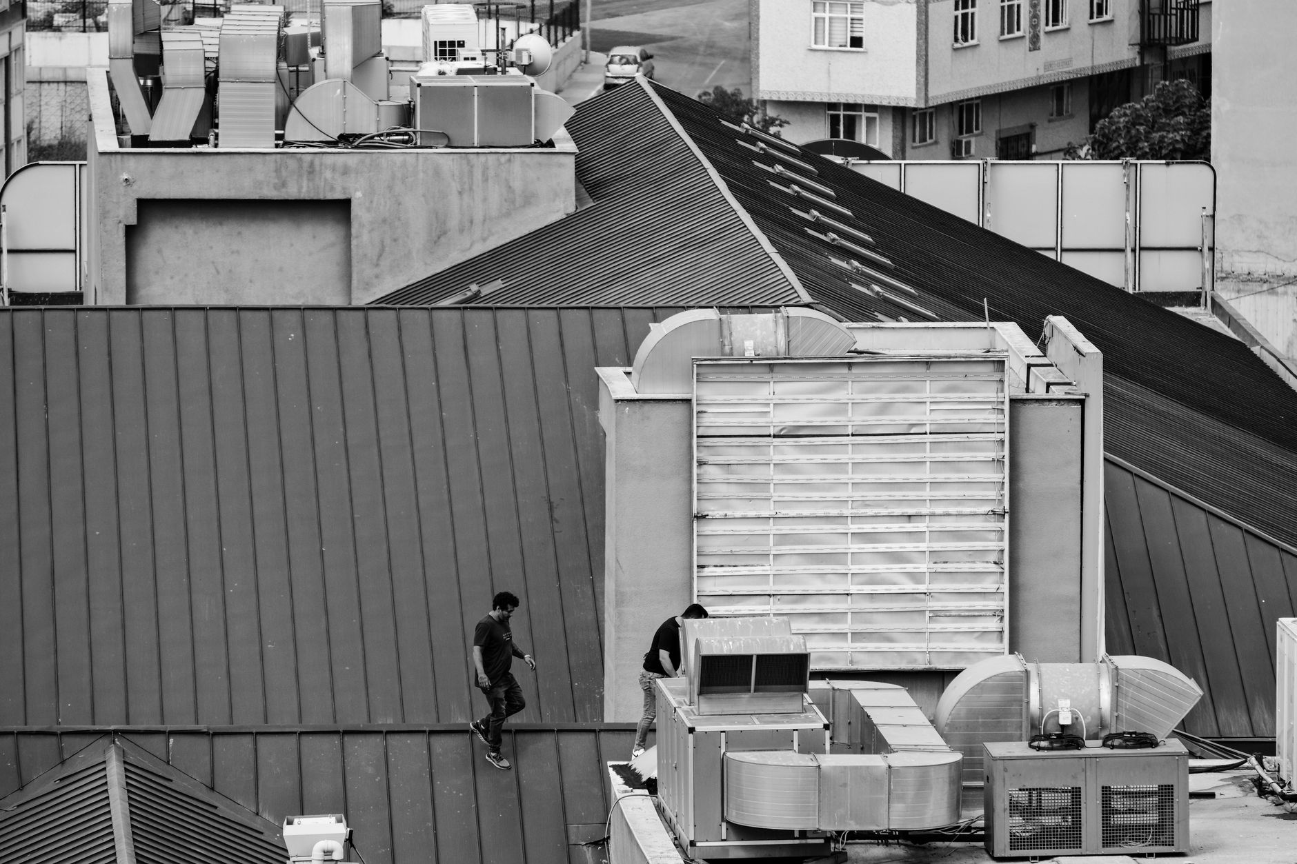A large industrial HVAC unit on a commercial skyscraper roof.