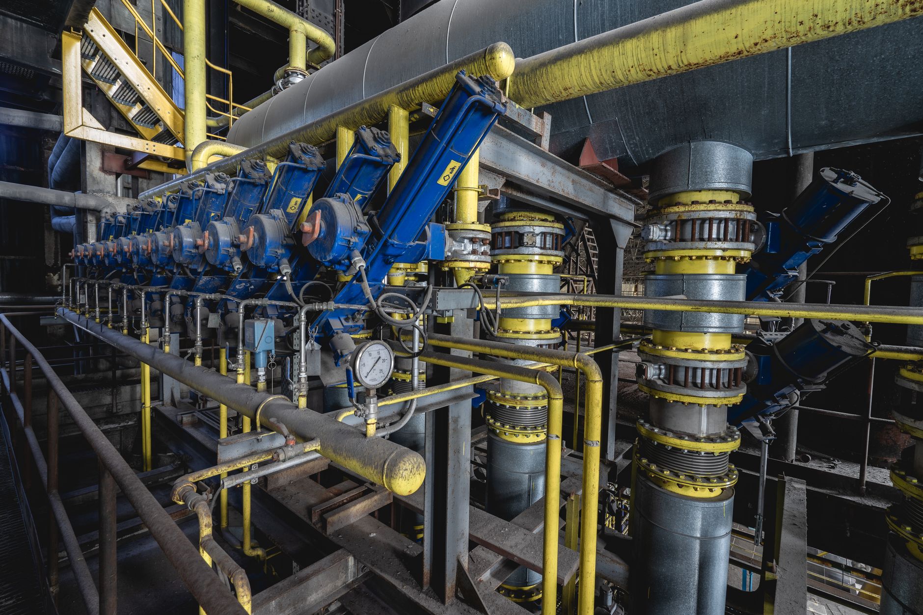A massive industrial desalination facility next to the ocean, featuring complex piping and chemical separation tanks.