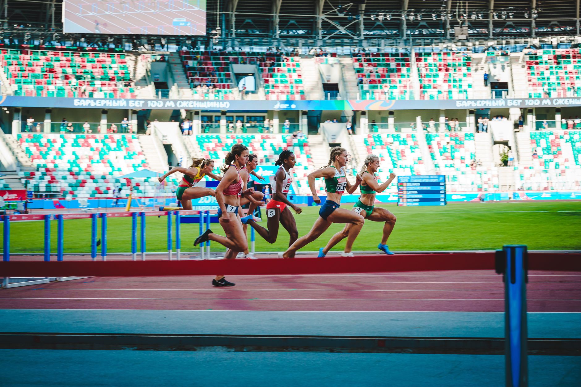 A high-contrast photograph of a professional athlete's silhouette against a digital display of biometric data graphs.