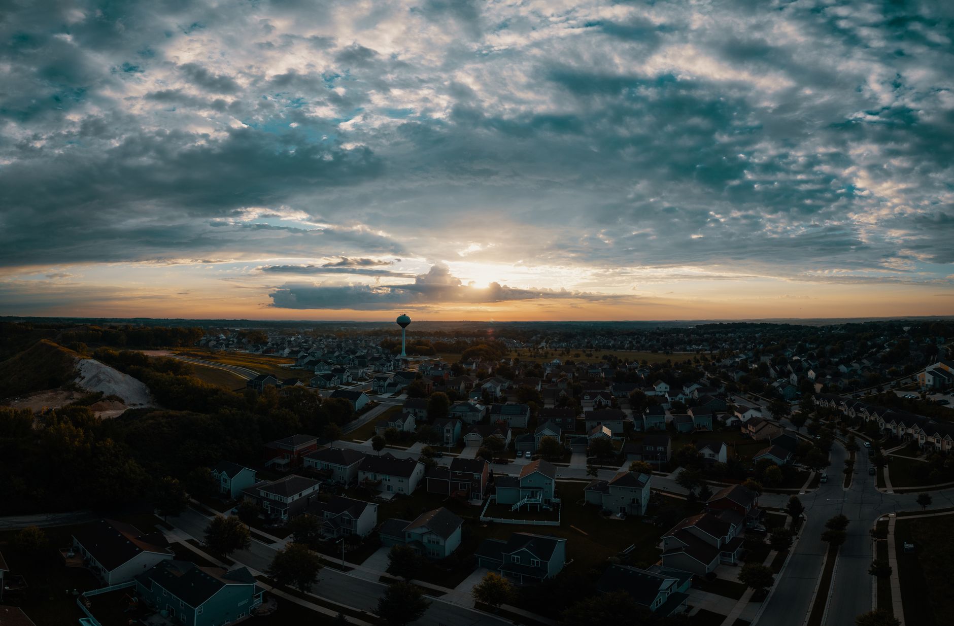 A surreal illustration of residential homes connected by glowing geometric grids in the sky, representing digitized air rights, with small drones flying through designated light corridors.