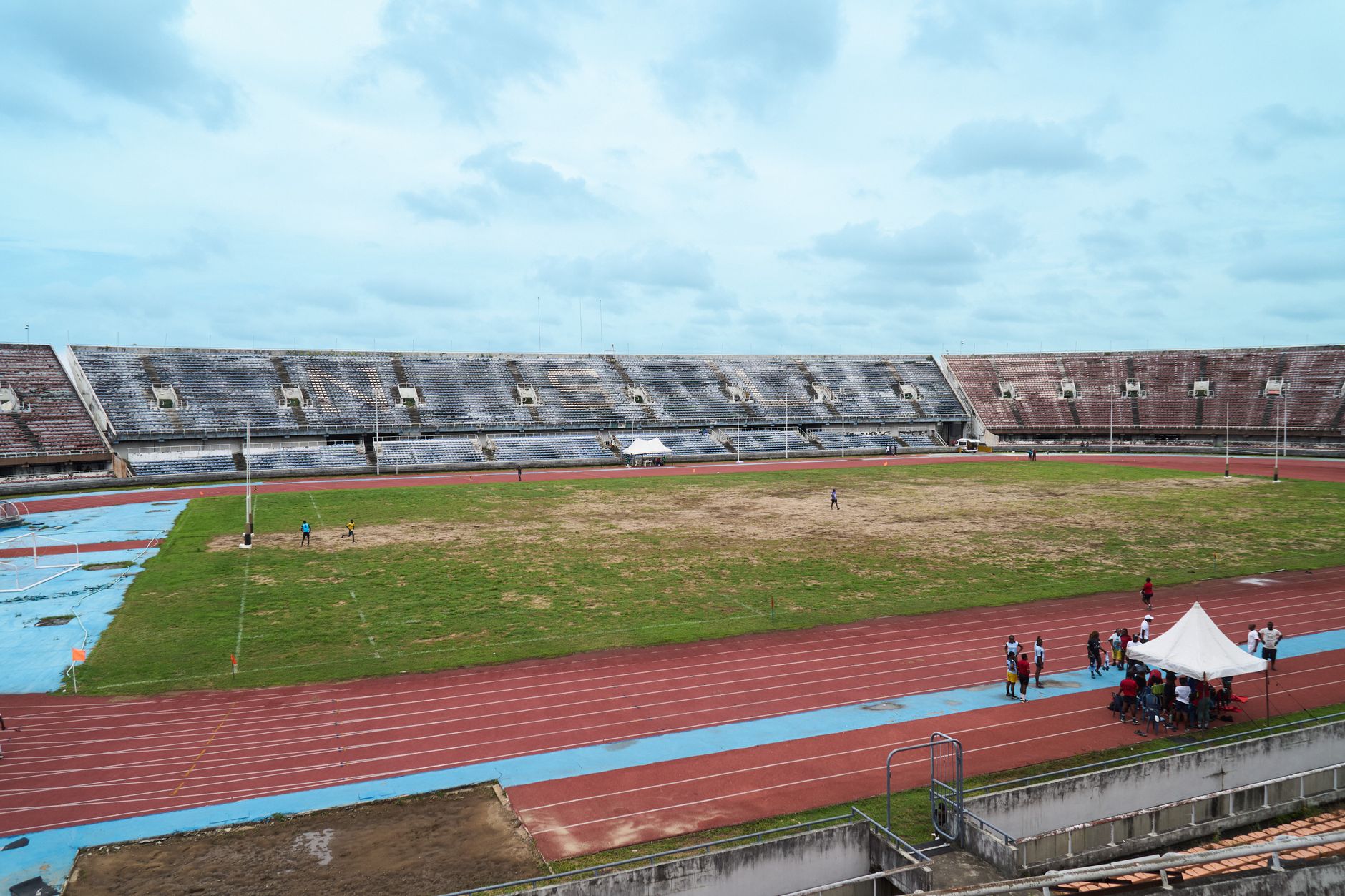 A high-contrast editorial illustration showing a corporate boardroom table blending into an athletic track.