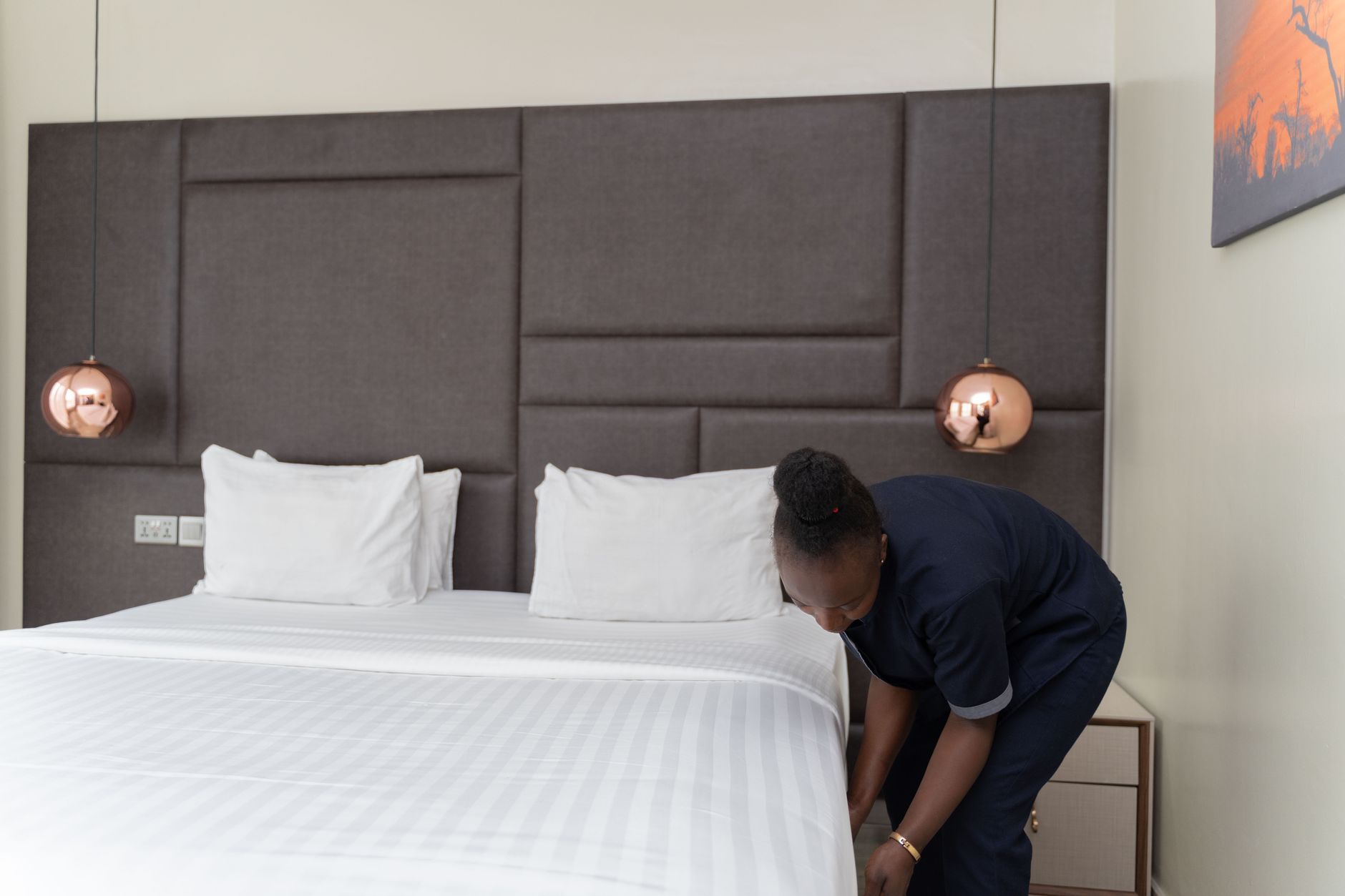 A luxurious hotel room featuring subtle, integrated medical equipment and a mechanical bed disguised as modern furniture.